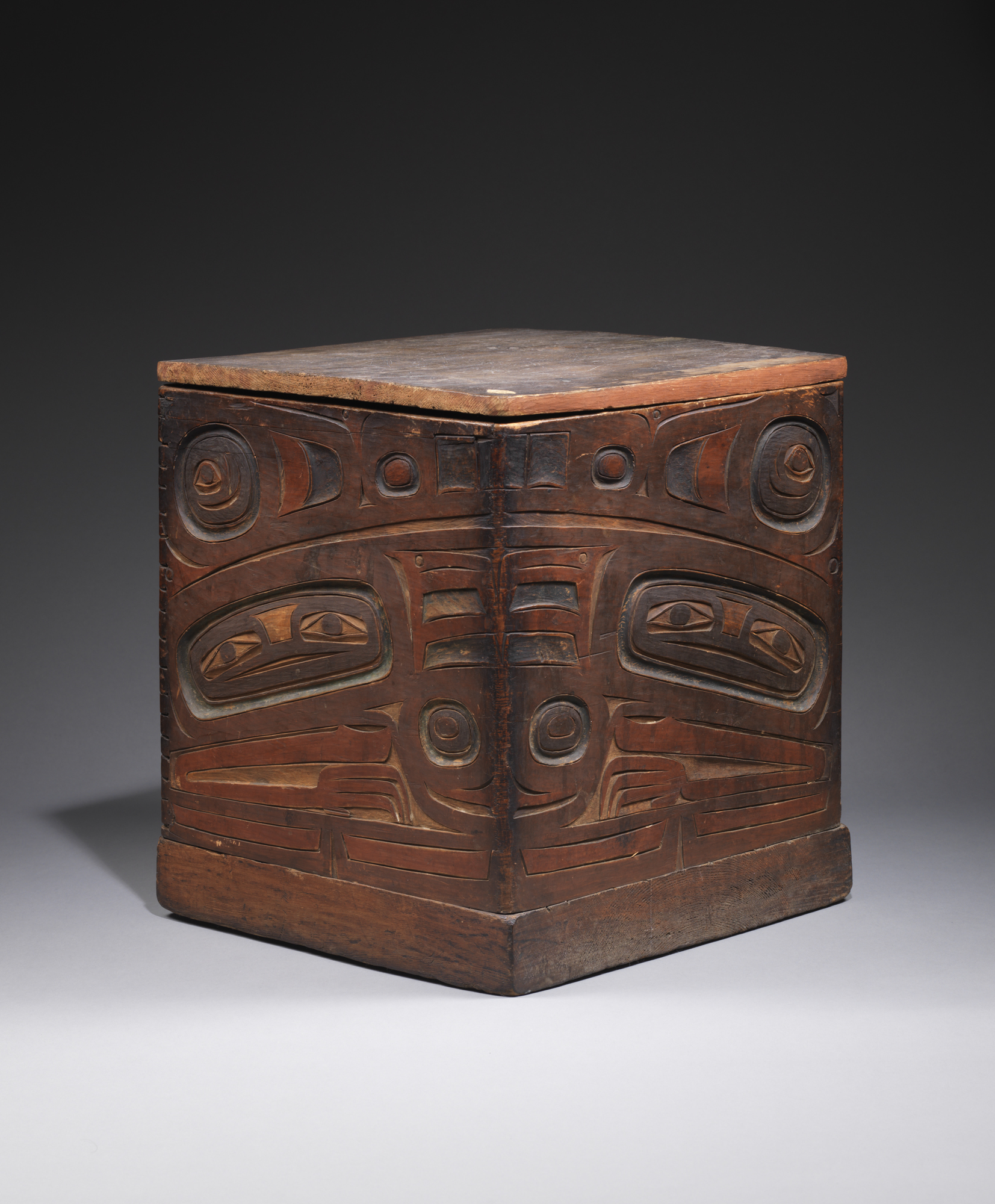Tlingit. Chest and lid with painted totemic carving, 19th century. Wood painted in shades of red, black, and sea green with cedar or spruce stitching. Lent by the Department of Geology and Geophysical Sciences, Princeton University.
